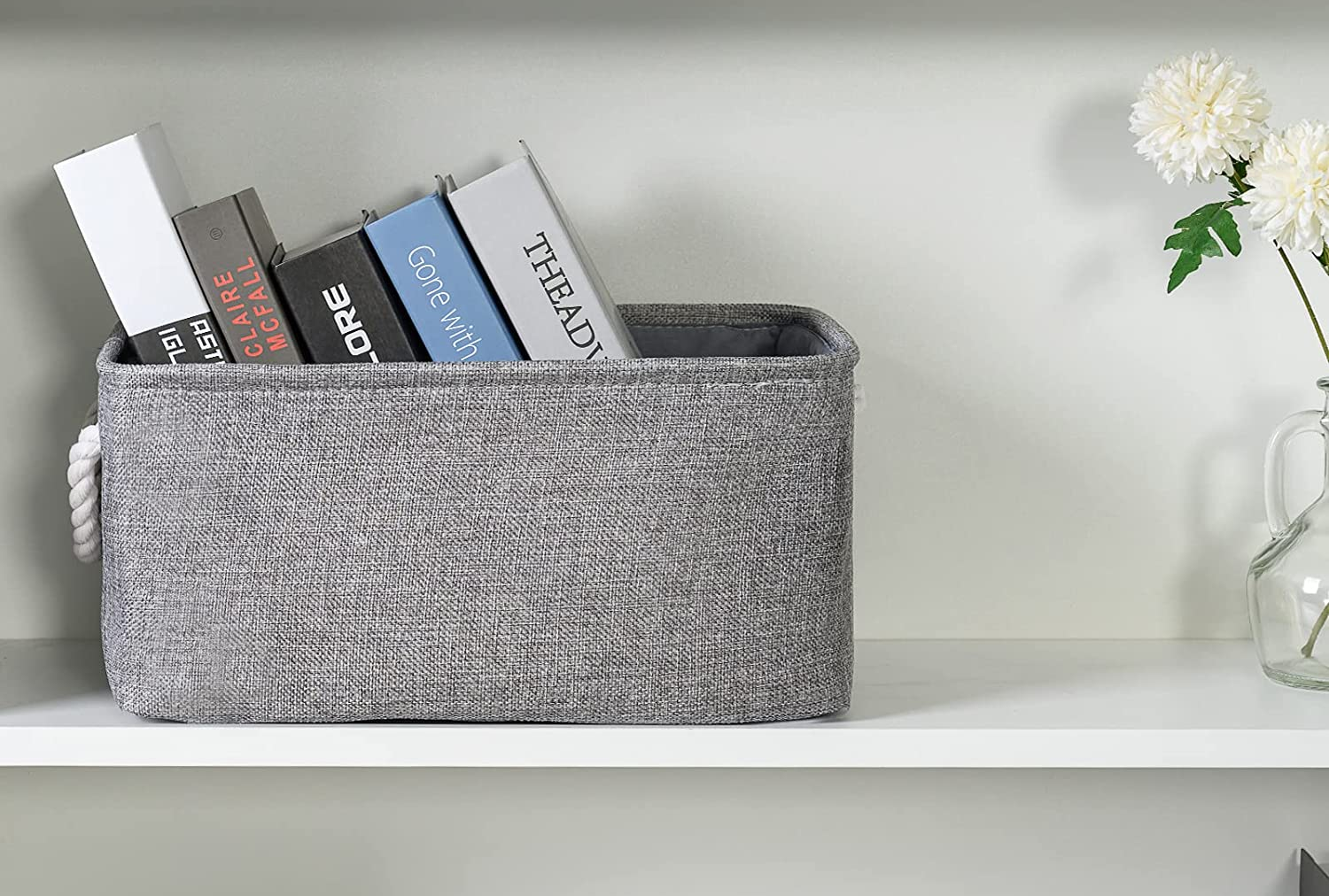 gray linen basket holding several books