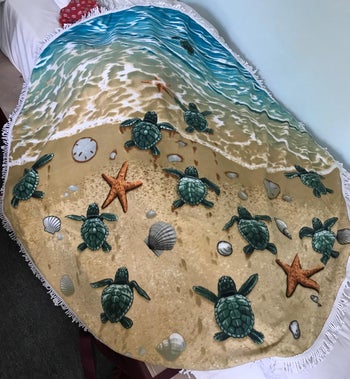 Reviewer image of round beach towel with turtles and sand design