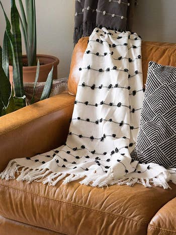 the white throw blanket on a couch