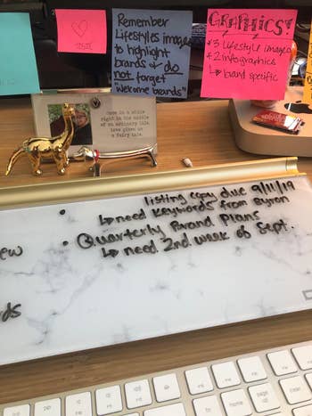 close-up of the marble-style whiteboard on a reviewer's desk with notes on it