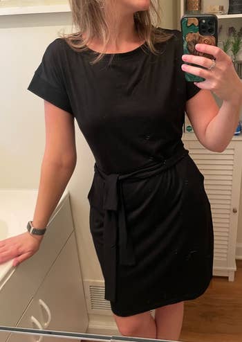 a reviewer wearing the black t-shirt dress