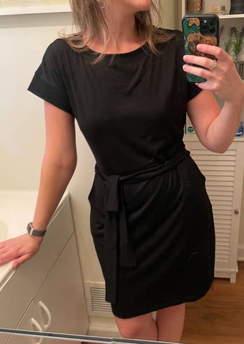 a reviewer wearing the black t-shirt dress