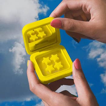 model holding the yellow compact packaging