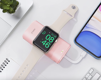 an Apple watch on the charger and the plug in an iPhone