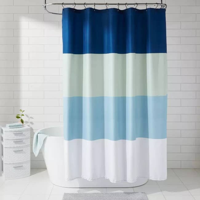 blue striped shower curtain in a bathroom