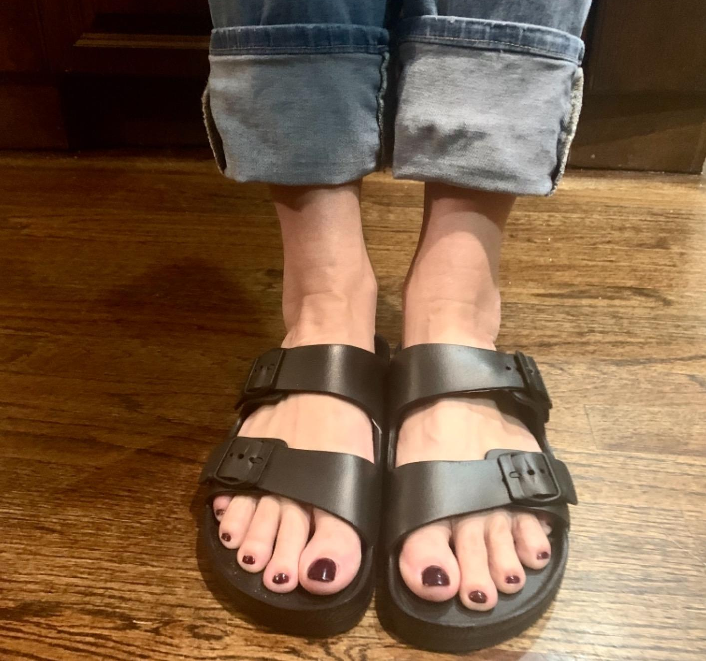 reviewer in the black two-strap slides