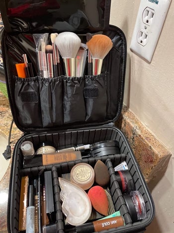 reviewer photo of the makeup bag full of makeup 