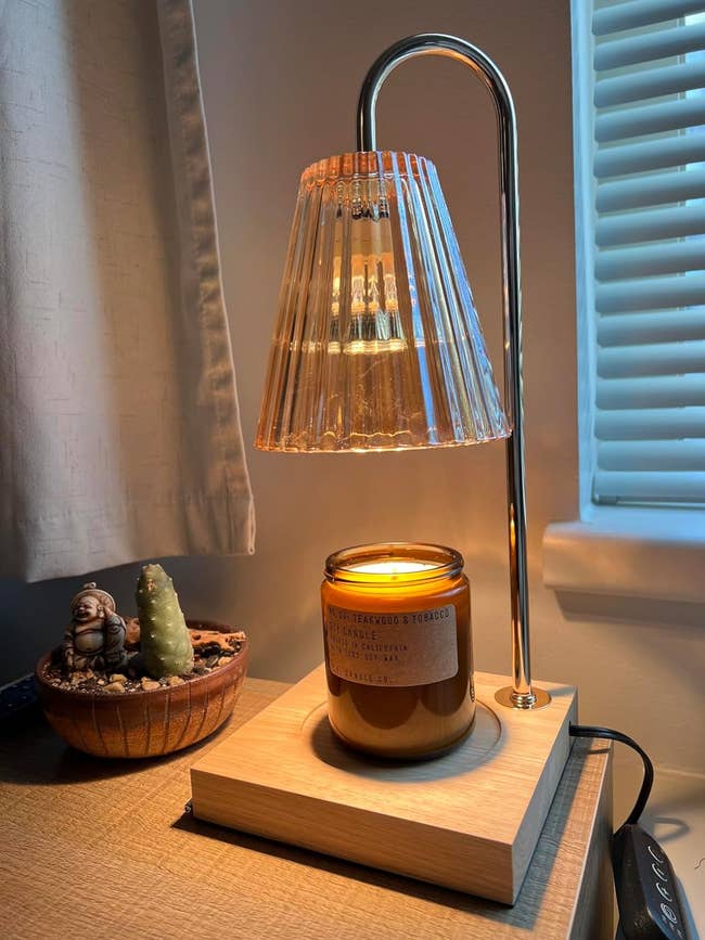 reviewer's candle warmer with a candle placed on wooden stand