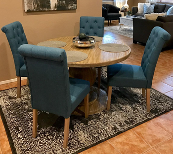 reviewer photo of four blue chairs at a round dining table