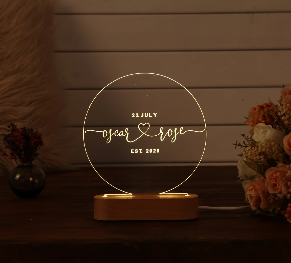 a lit round glass sign reading