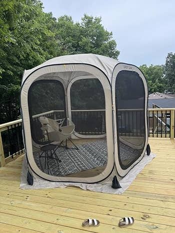 Outdoor playpen connected a woody deck, acceptable with a tiny seat inside. Trees are disposable successful the background