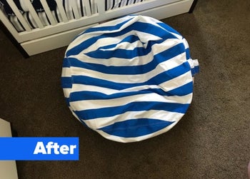 Reviewer's after photo showing  a tidy room with the stuffed animals hidden inside the bean bag cover