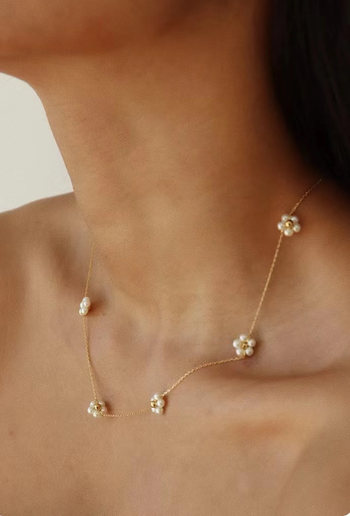 a different angle of the same model wearing the same necklace