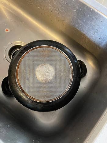 reviewer's pot with stains gone after using The Pink Stuff