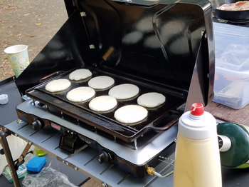 Reviewer's small round pancakes on a griddle 