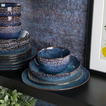 Stacked ceramic dinnerware acceptable   with textured patterns connected  a acheronian  shelf, adjacent  to a framed botanical print. Ideal for room  and dining