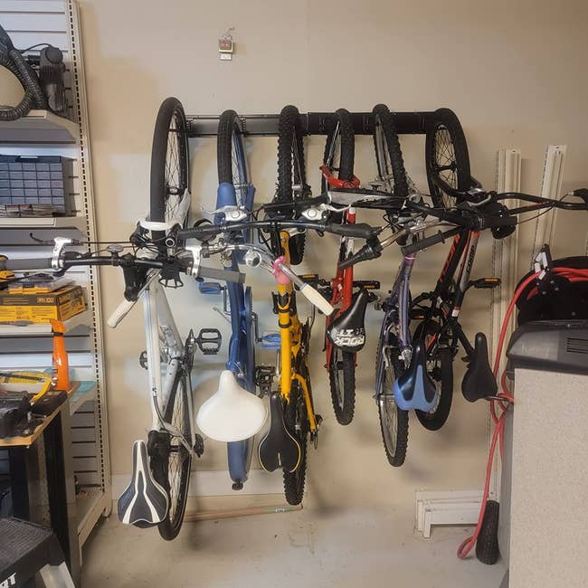 a reviewer's six bikes hanging on a mount on a wall