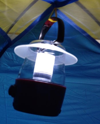 reviewer photo of mini camping lantern hanging on ceiling of tent