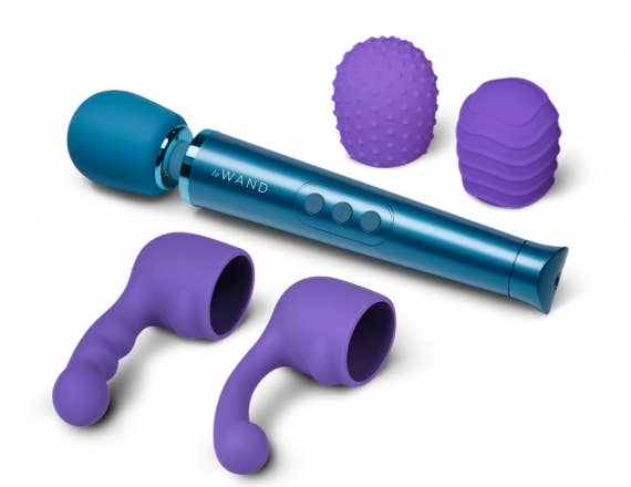 Teal wand vibrator next to two purple silicone attachments and two purple textured silicone covers