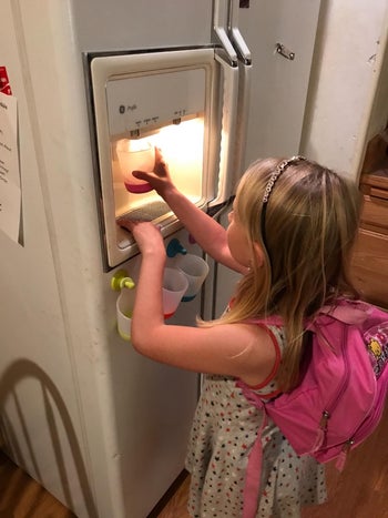 A child using the cups to get a drink of water