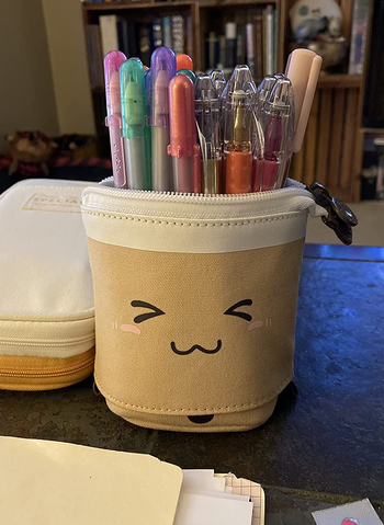 the boba tea holder holding a variety of pens