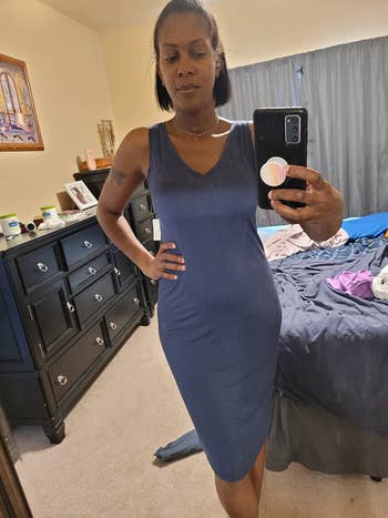reviewer in V-neck blue dress