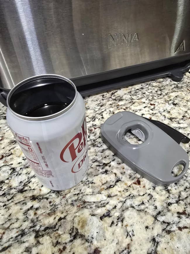 Diet Dr Pepper tin with sip lid connected granite antagonistic adjacent a toaster appliance