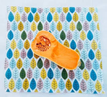 half of a butternut squash resting on a piece of colorful beeswax wrap
