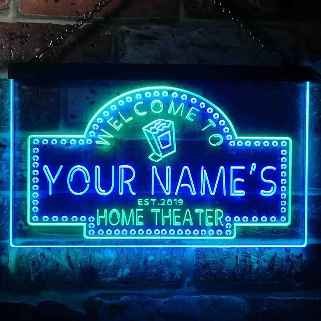 Neon motion reads Welcome to Your Name's Home Theater. Est. 2019