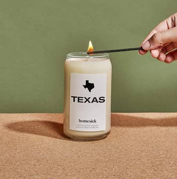 Homesick candle with state of Twxas on it