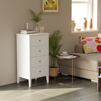 four-drawer white dresser in bedroom