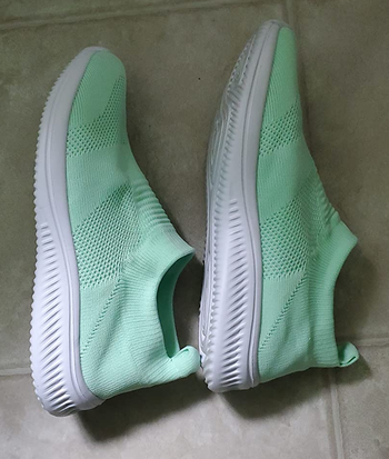 reviewer photo of the light green slip-ons 