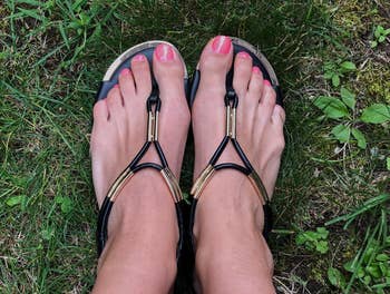 a reviewer wearing the sandals in black 