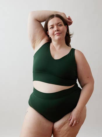model in a green sports bra and matching underwear