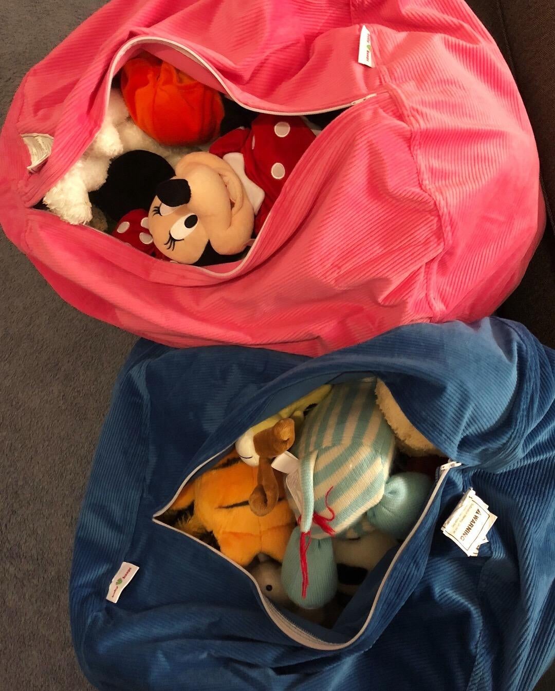 Reviewer's two bean bags on the floor opened with toys in them