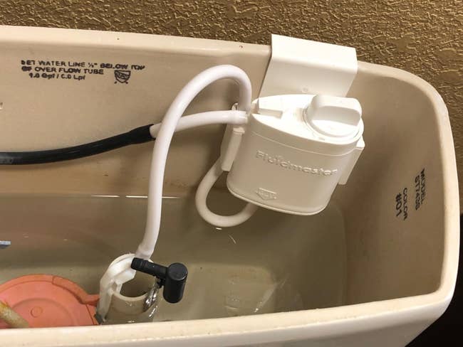FlushMaster automatic toilet flush mechanism installed inside a toilet tank