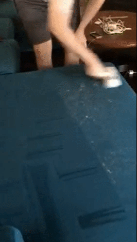 gif of reviewer using the chom chom to easily remove pet hair from a couch