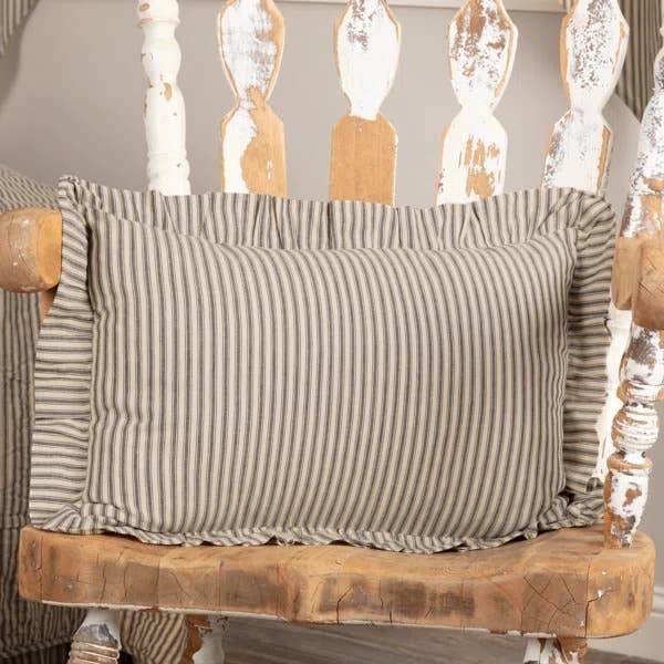 Striped cushion on rustic wooden chair with distressed finish