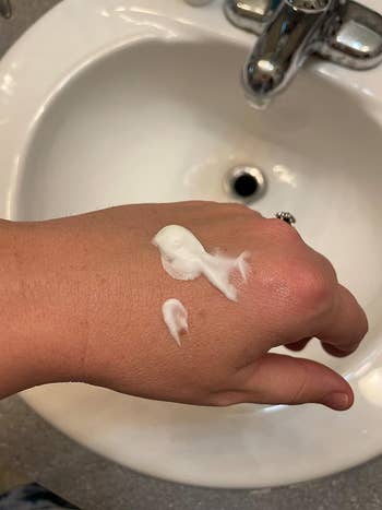 image of a dollop of the cream on a reviewer's hand