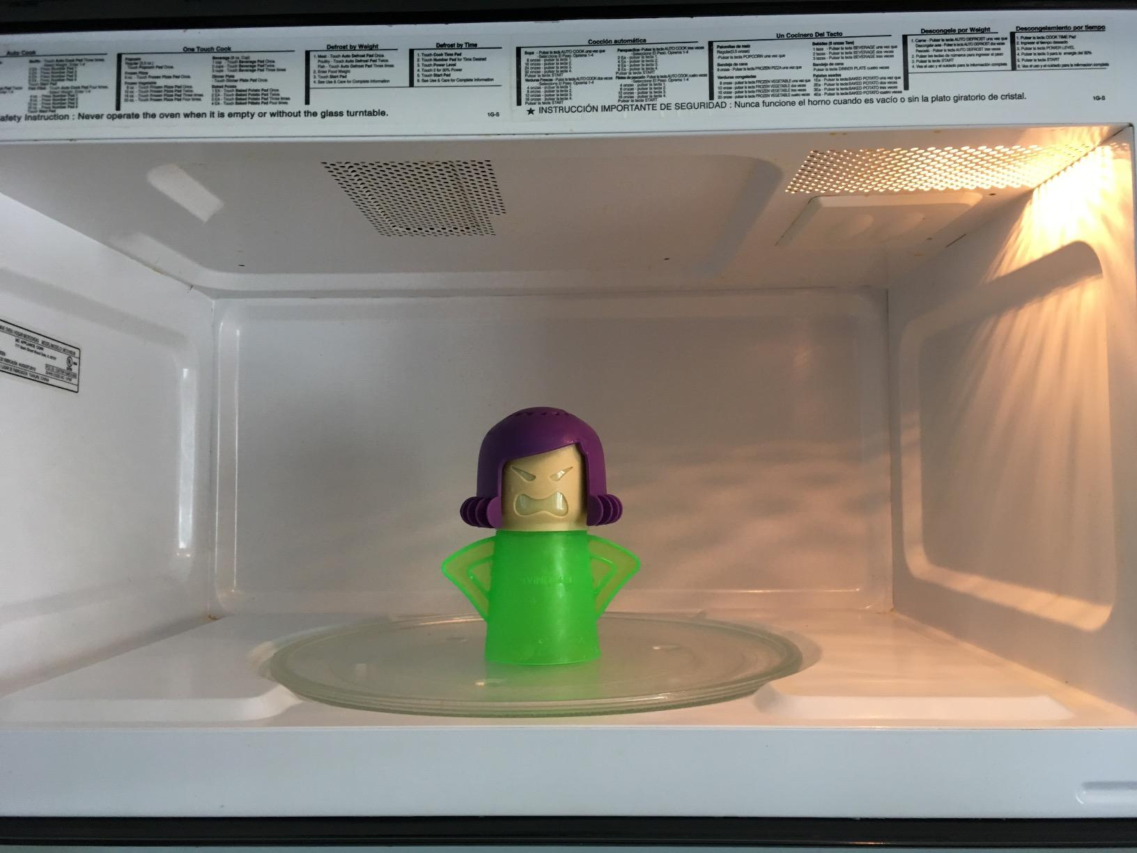 same reviewer's after photo of the angry mama in a clean microwave