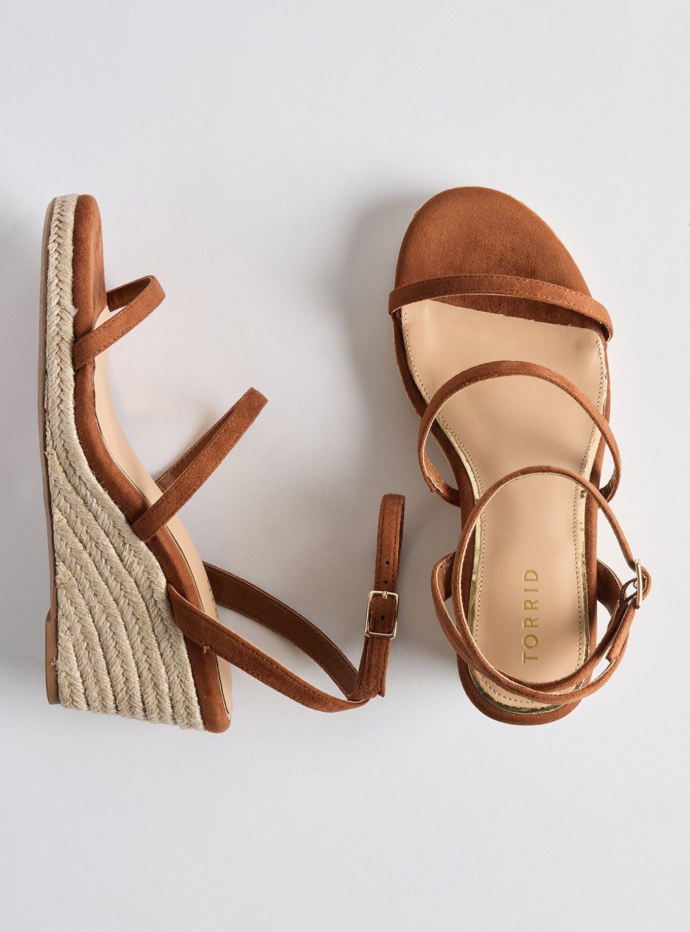 Pair of brownish  strappy wedge sandals with a woven platform, showing the marque  