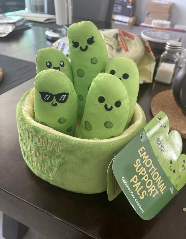 Plush pickles with cute faces, labeled