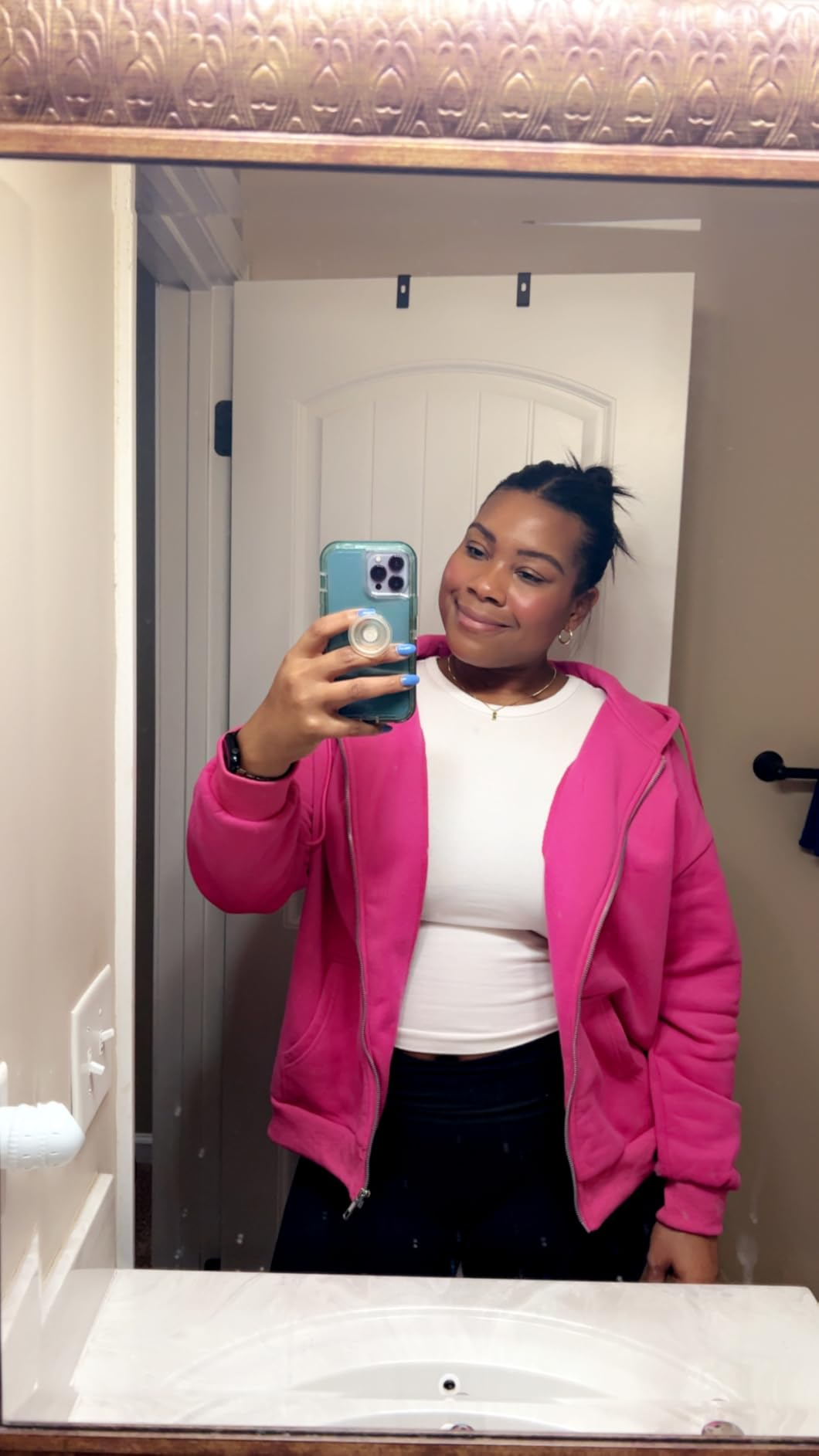Person takes a reflector  selfie wearing a casual pinkish  overgarment   implicit    a achromatic  top