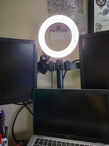 the ring light behind reviewer's monitors