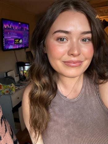 reviewer selfie wearing the moisturizer, skin in glowy 