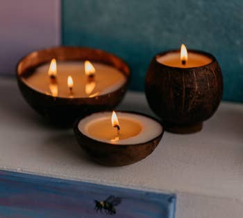 Image of three lit coconut candles