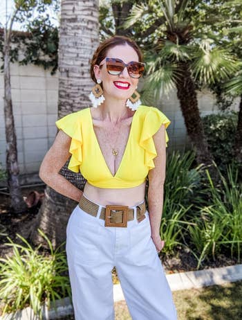 reviewer wearing the yellow top with pants