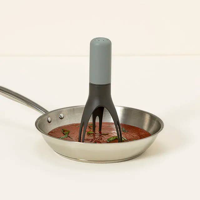 the pan stirrer in a pan of sauce