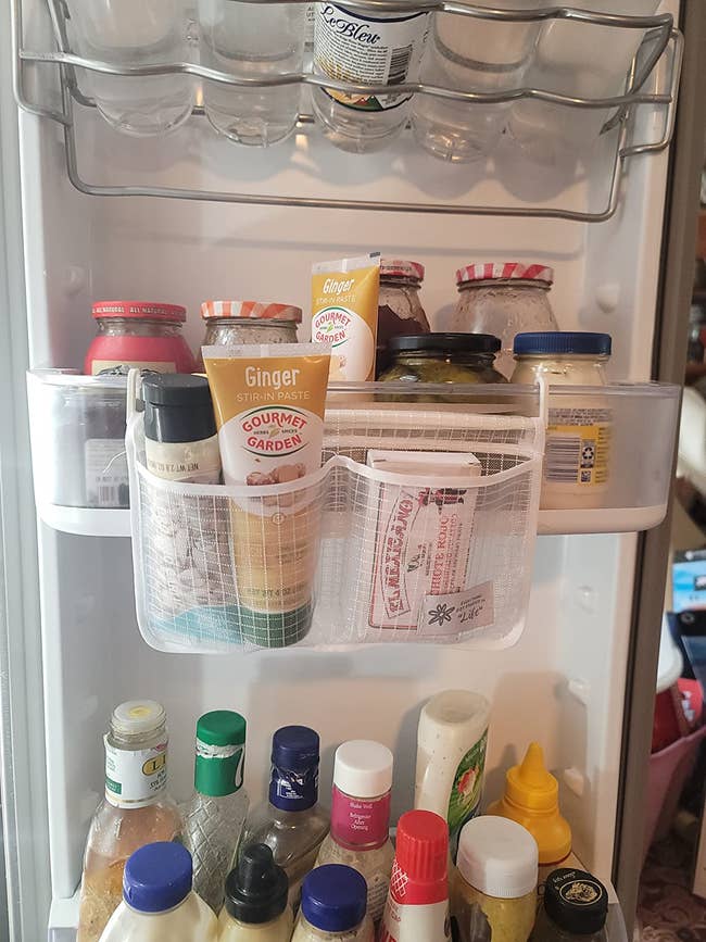 Organized refrigerator doorway with assorted condiments similar mustard, soy sauce, and ginger paste neatly arranged