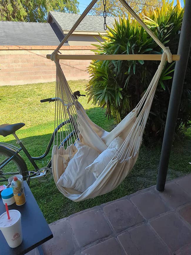 reviewer image of the hammock chair hanging on a patio